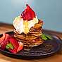 Servera bananpannkakorna med en klick grädde och färska bär
